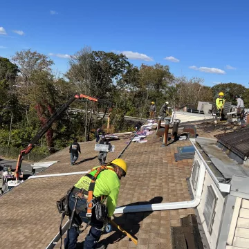 A_team_of_skilled_laborers_are_carefully_installing_shingles_on_the_roof,_ensuring_a_durable_and_long_lasting_finish_by_The_Premium_Roofing_in_Brooklyn_New_York
