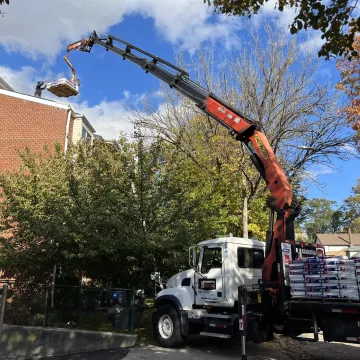 Transfering_roofing_material_from_ground_floor_to_top_floor_for_roofing_with_the_help_of_crane_in_Brooklyn_New_York